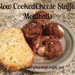 Cheese stuffed meatballs with a slice of garlic bread on a green plate.