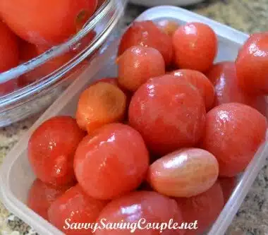 Skinless blanched tomatoes in a rectangular container.