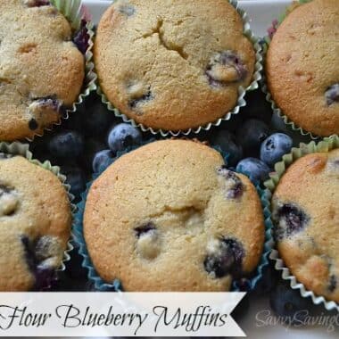 Almond Flour Blueberry Muffins on a white plate with fresh blueberries