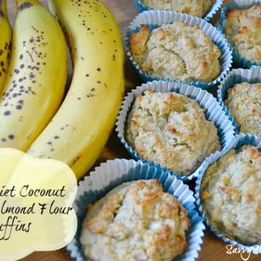 Paleo Diet Coconut Banana Almond Flour Muffins on a wooden cutting board with speckled bananas.