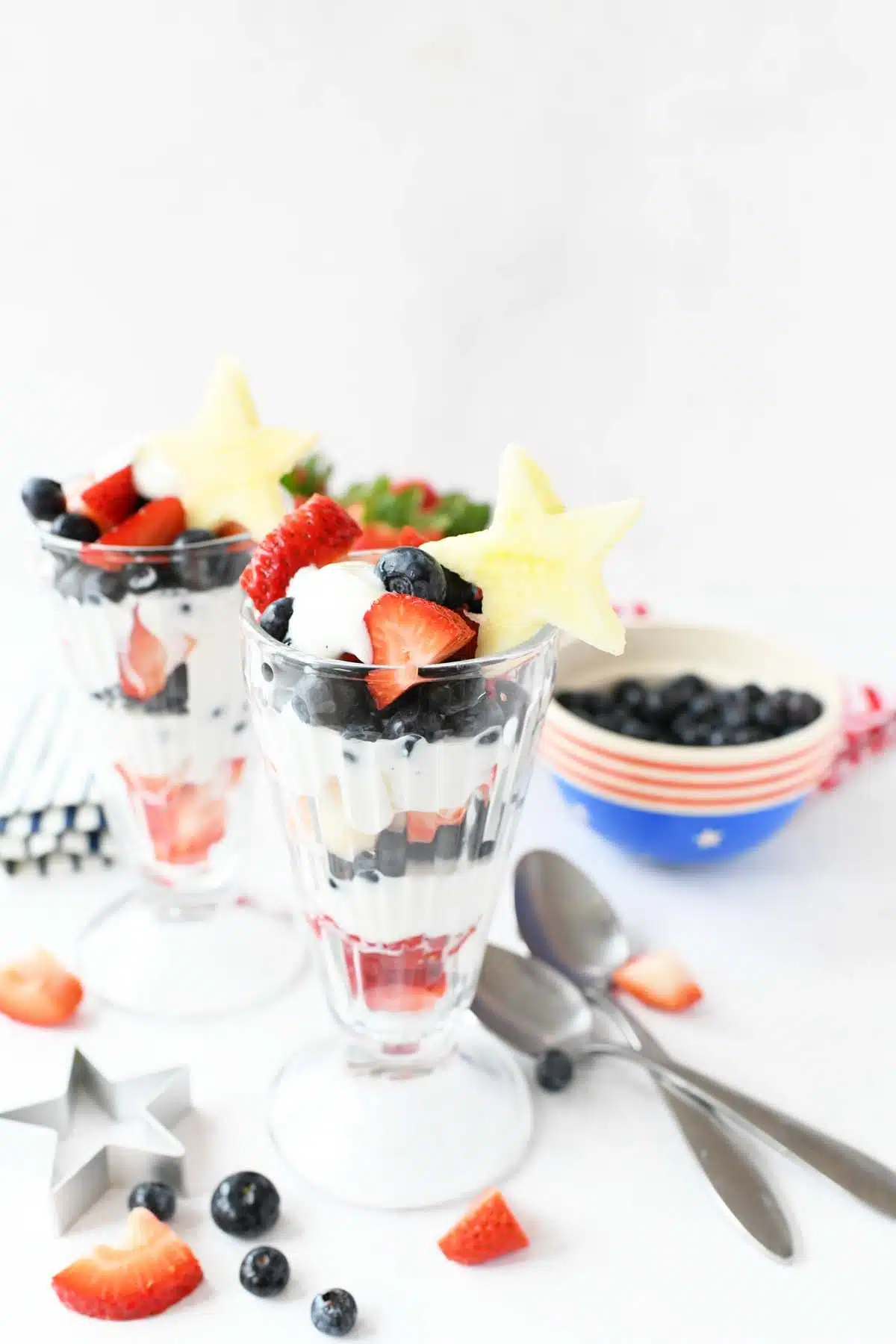 Patriotic Fruit Parfaits with berries, and apple star toppers.