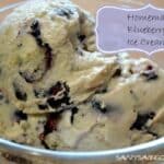 Blueberry Ice Cream Scoops in a clear, glass dish.