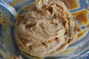 Peanut butter cookie dough in a glass bowl.