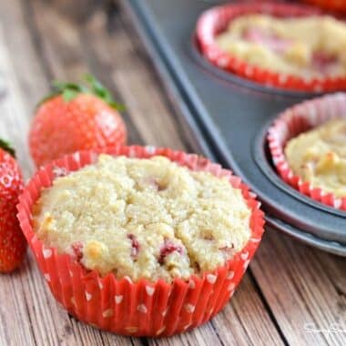 Strawberry almond flour muffins in red and white cupcake wrappers.