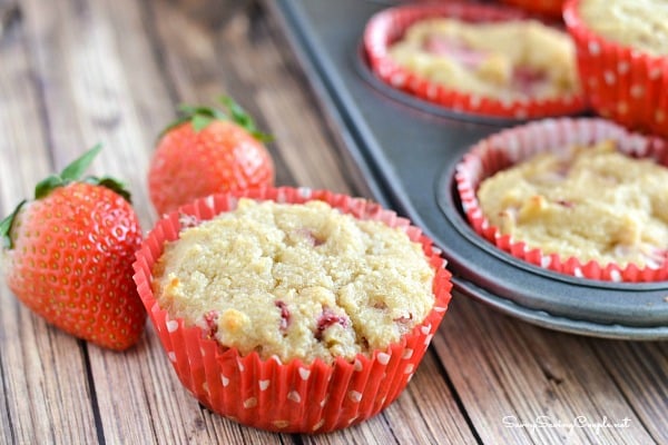 Strawberry almond flour muffins in red and white cupcake wrappers.
