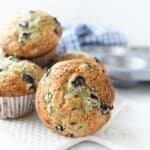 Jumbo blueberry muffins on a white tray.
