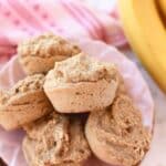 Oatmeal and banana muffins on a pink plate.