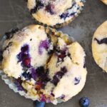 Blueberry Muffins opened up on silver pan.