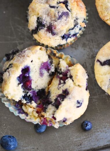 Blueberry Muffins opened up on silver pan.