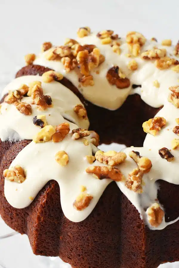 Up close shot of Banana Bundt Cake with cream cheese and walnut frosting. 