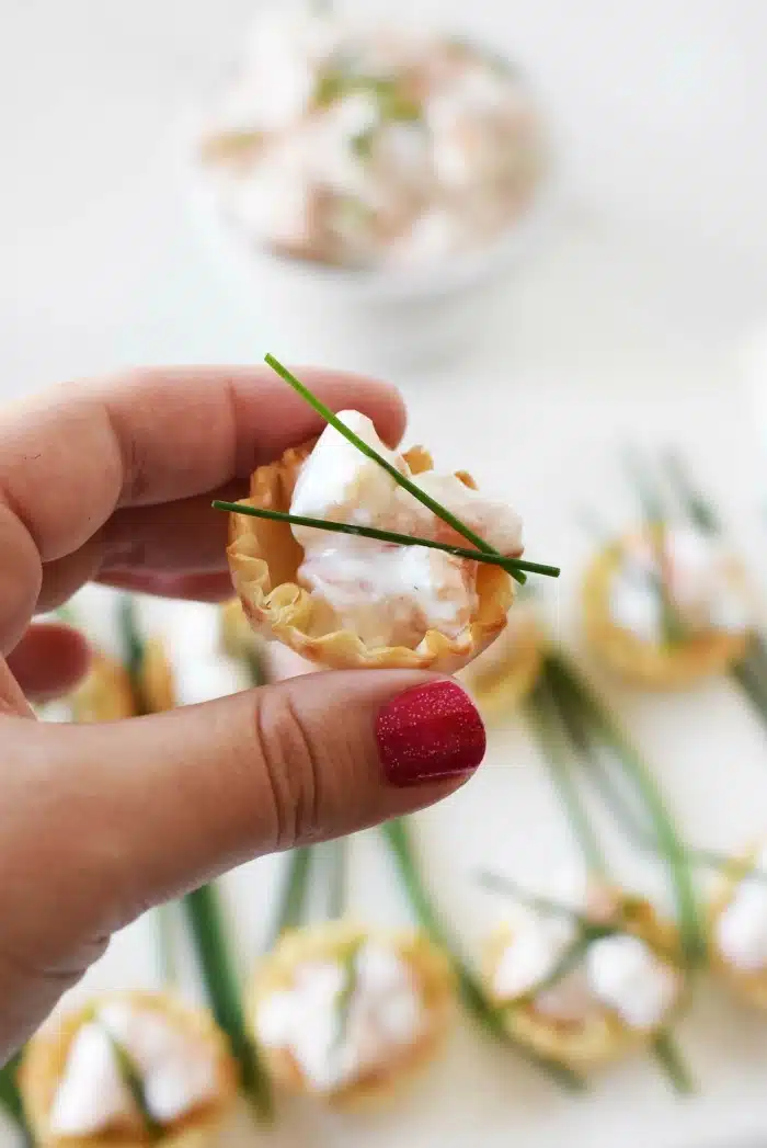 Shrimp Tarragon Bites in hand.