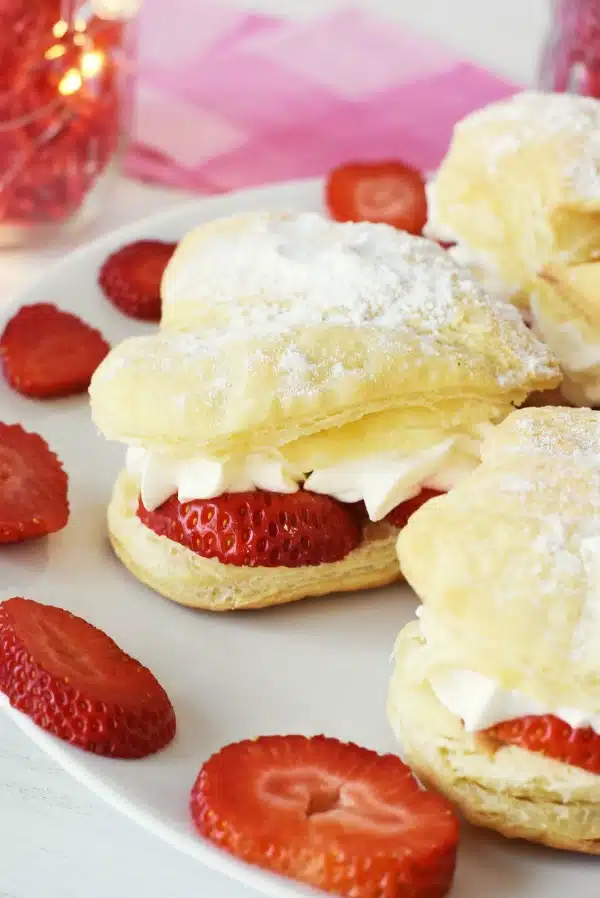 Strawberry heart-shaped cream puff on a plate. 