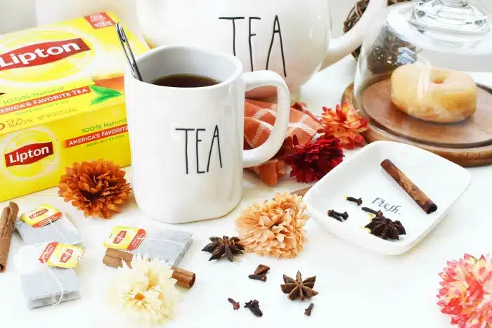 Lipton Spiced Black Tea inside a mug that says tea, warm spices, and fall floral accents.