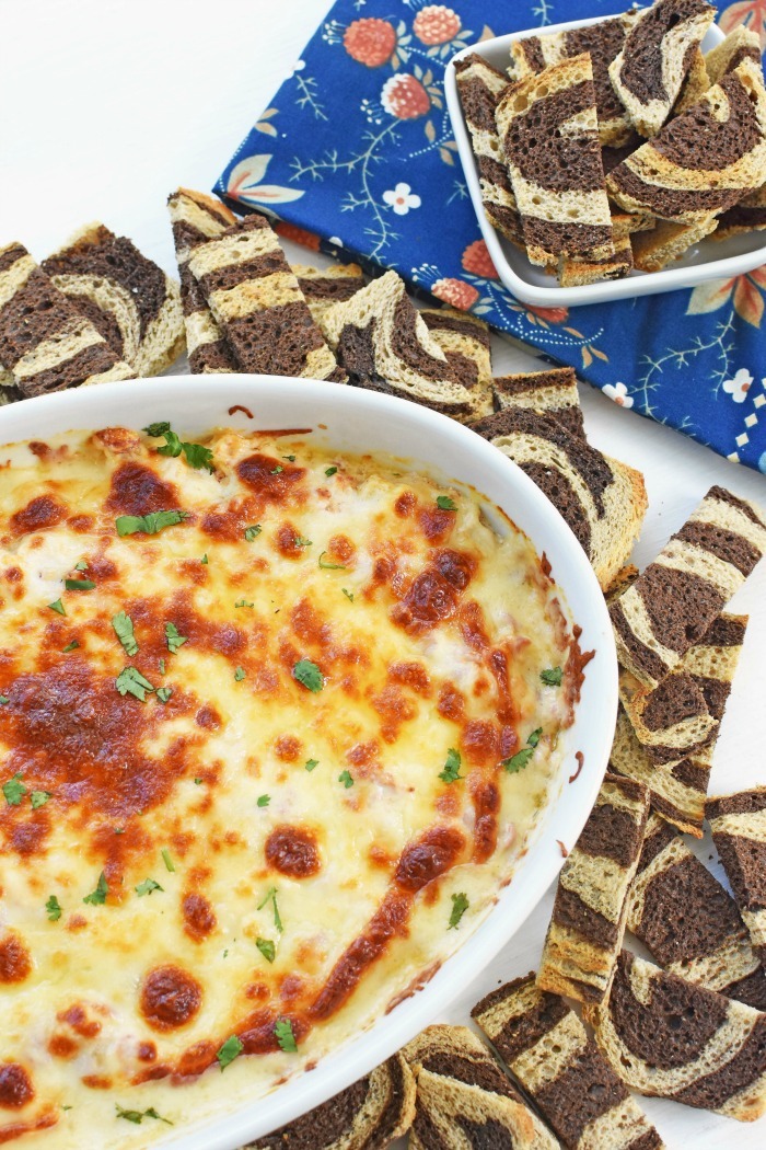 Corned Beef Reuben Dip near rye squares with w blue flowered napkin