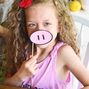 Girl with pink paper piggie nose