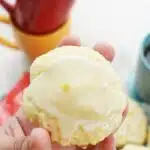Iced Lemon Ricotta Cookie in a white hand.