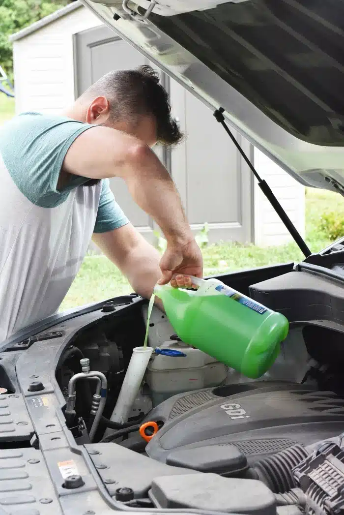 Man adding windshield washer fluid 