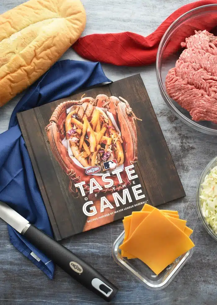 Kingsford Taste of the Game cookbook on grey table. 
