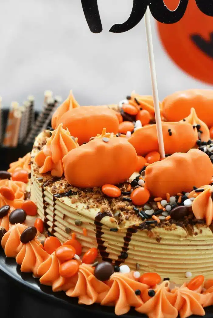 Reeses Halloween Ice Cream Cake with orange Reeses pumpkins on top.