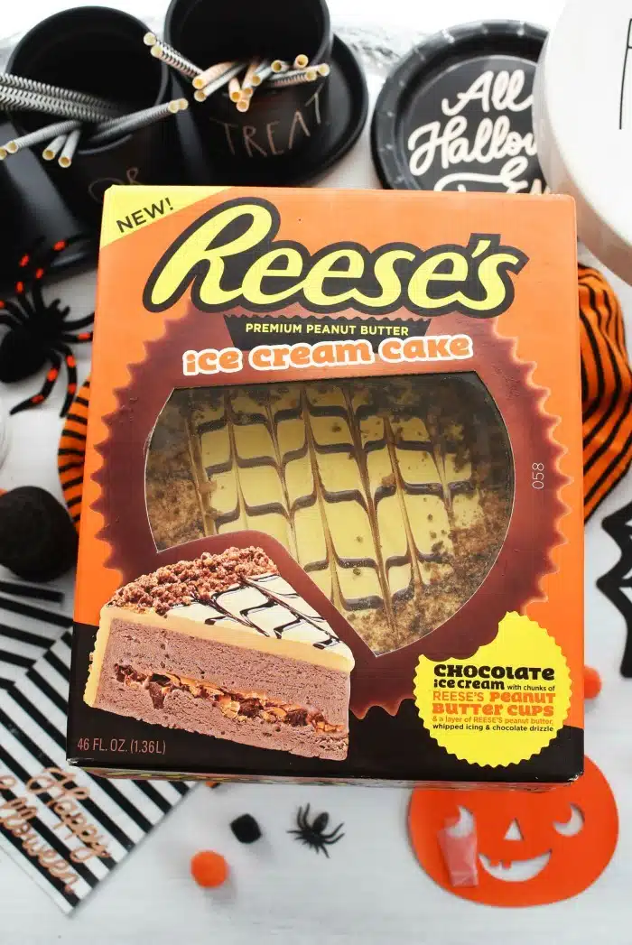 Reeses Ice Cream Cake in box on Halloween themed table.