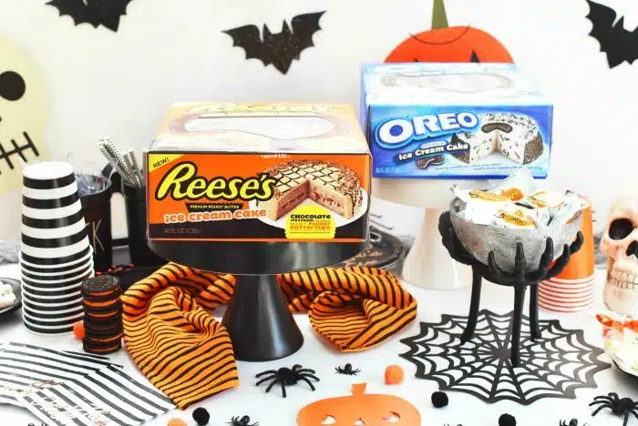 Reese's and Oreo Ice Cream Cakes on Halloween themed table.