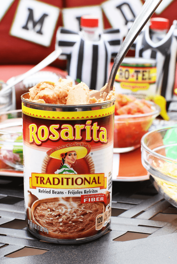 Rosarita Beans on patio table near food. 