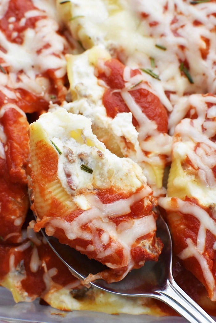 Sausage and Bacon Stuffed Pasta Shells on silver spoon. 