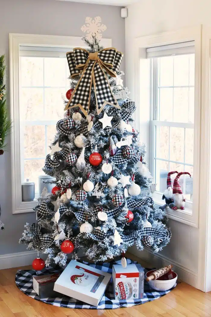 Farmhouse Rae Dunn inspired red and buffalo plaid tree with gifts underneath. 