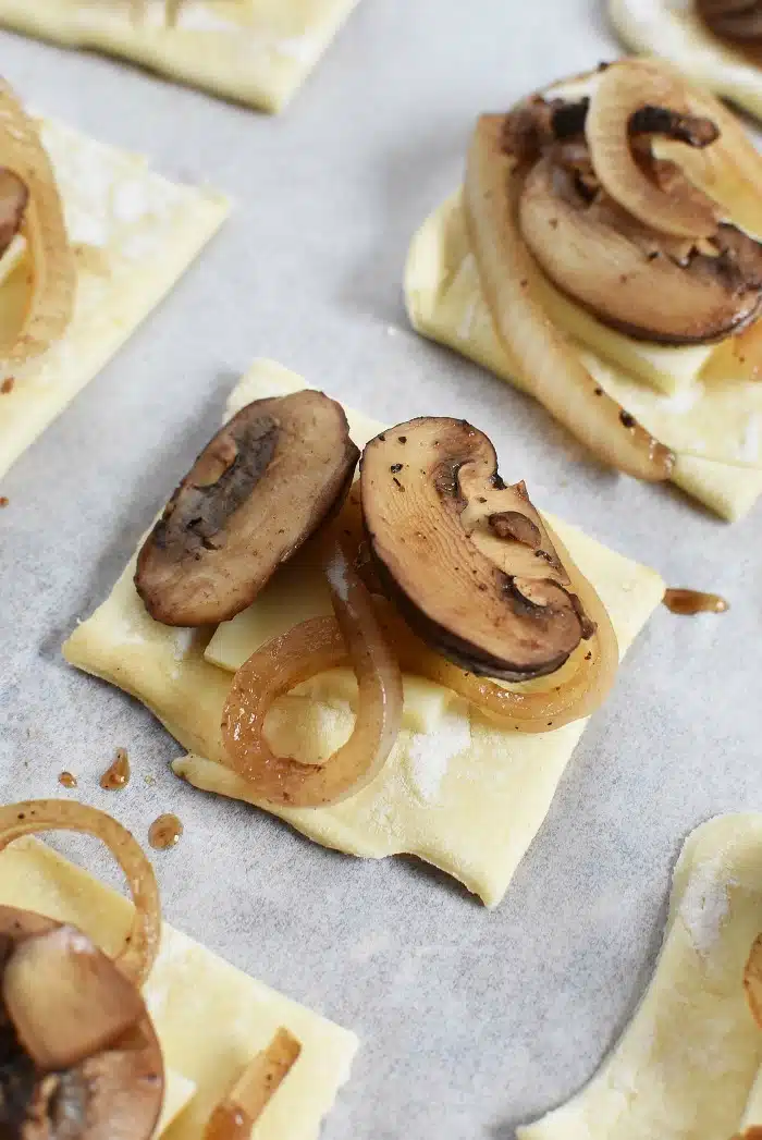 Mushroom and onion on pre-baked puff pastry squares. 