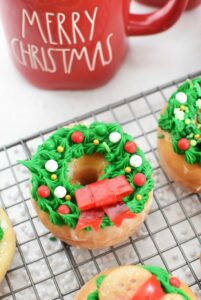 Wreath donut on baking sheet with red candy bow