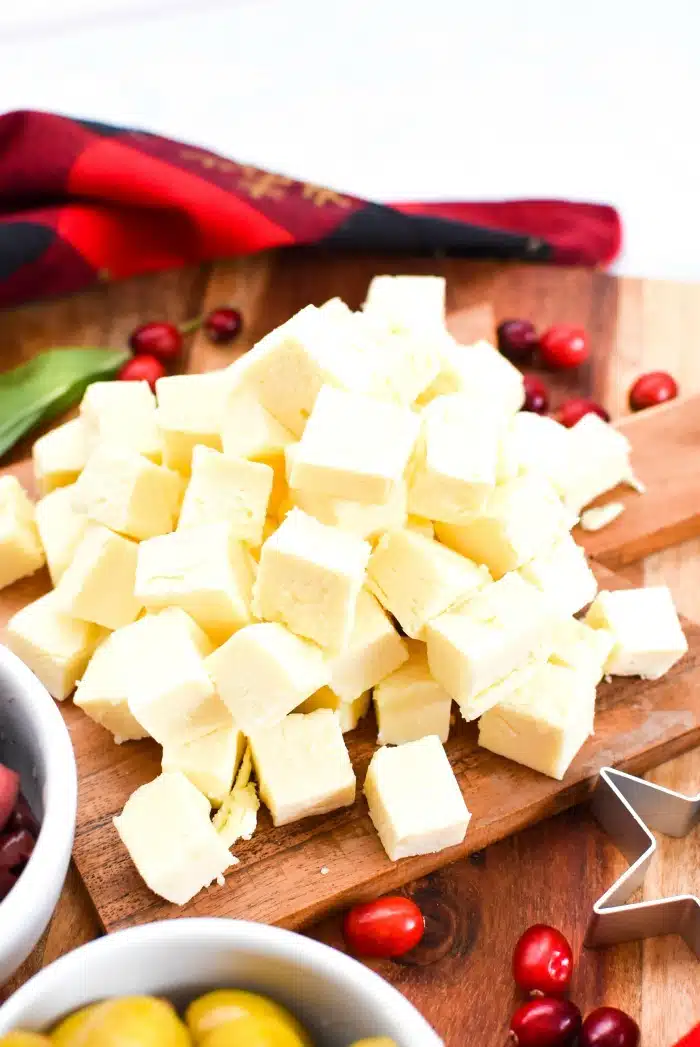 Cooper Cheese Cubes on wooden cutting board. 