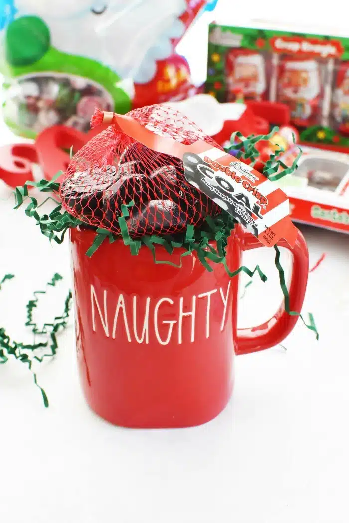Naughty Red Christmas mug filled with chocolates. 