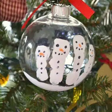 diy snowman ball ornament with white paint fingerprints as snowmen