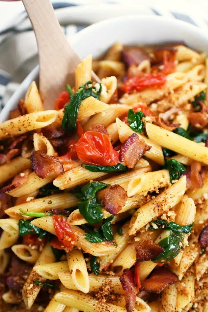 BLT pasta recipe idea up close in a spoon. 