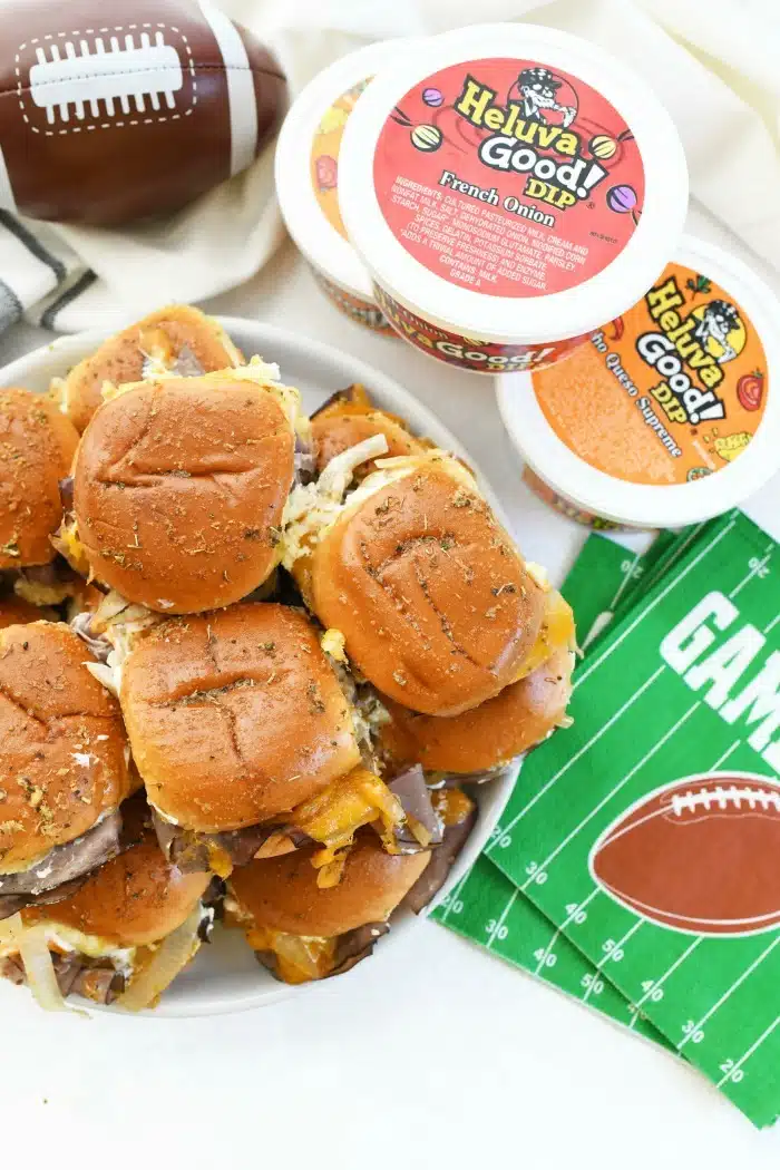 Baked Roast Beef Sliders on platter near game day napkins and dip.