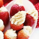 Cheesecake Stuffed Strawberries on a heart shaped plate. plate