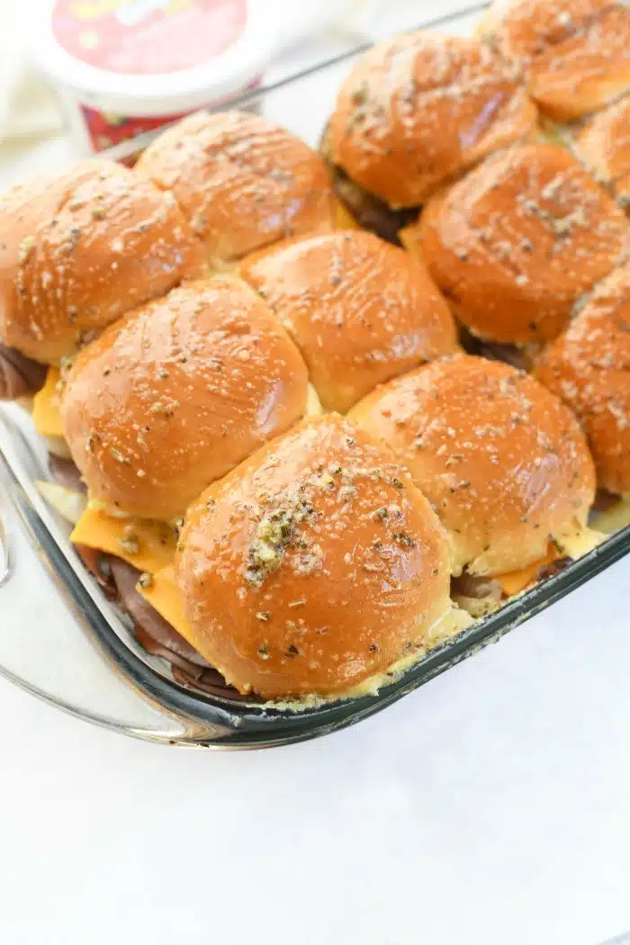 Garlic Herb Butter Brushed Sliders in glass baking sheet.