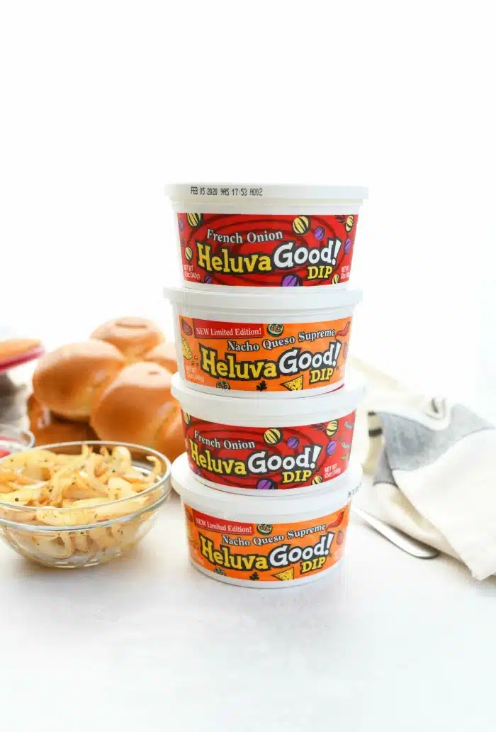 Heluva Good Dip stacked on top of each other. There are three in the image with cooked onions.