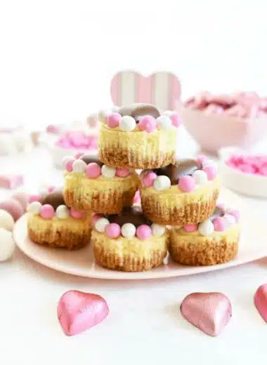 Mini Valentine's Cheesecakes stacked on a heart-shaped plate.