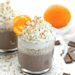 Orange Hot Chocolate Recipe on a white table with orange and zest