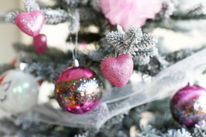 Pink heart ornament with glitter on it. 