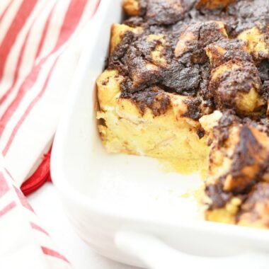 French Toast Casserole with a piece missing in a rectangle baker.