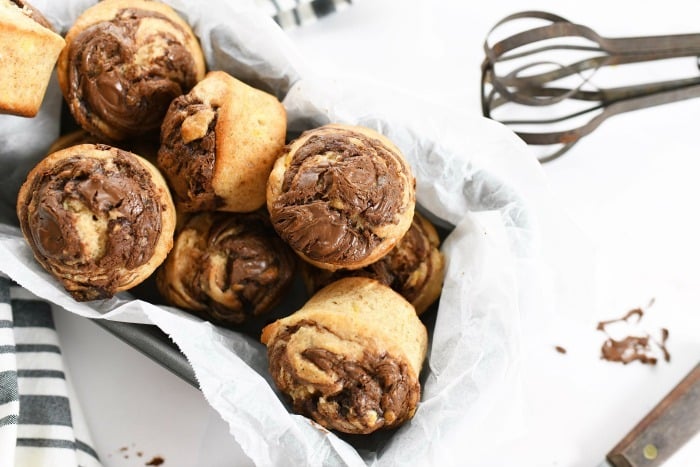 Nutella Banana Muffins in parchment-lined tin. 