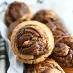 Nutella Swirl Banana Muffins in parchment-lined loaf pan