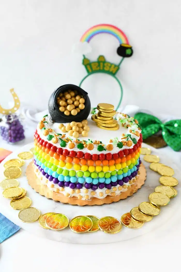 Rainbow Cake decorated with rainbow and gold candy Sixlets. 
