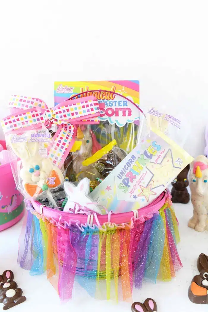 Colorful pink Easter basket with unicorn candy. 