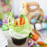 Easter Egg in Grass Cupcakes on a wooden platter.