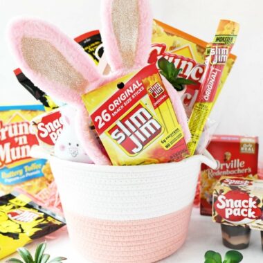 Girl's pink easter basket with snacks and pink bunny ears