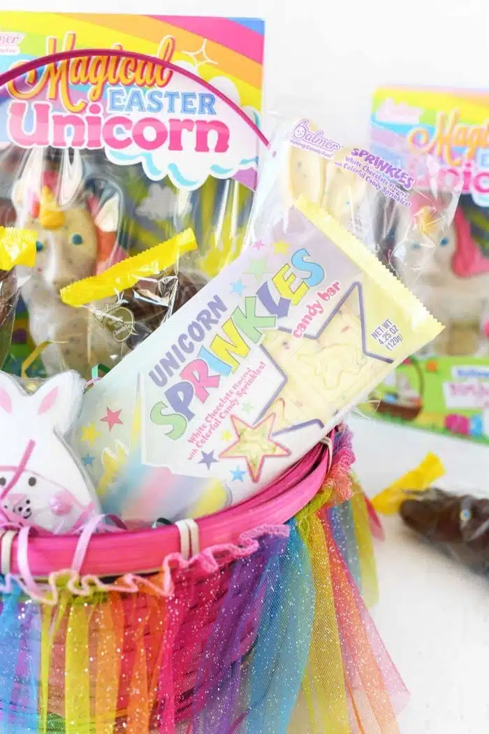 Unicorn sprinkles candy bar in Easter basket. 
