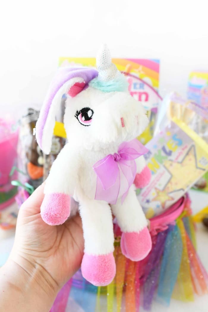 Stuffed Unicorn with Easter basket in the background. 